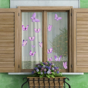 Set of decorative purple butterfly window stickers applied on glass for home decor