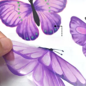 Detail of purple butterfly window sticker showing double-sided colorful pattern design