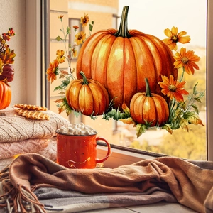 Watercolor pumpkin and sunflower window stickers for autumn home decor on a glass pane