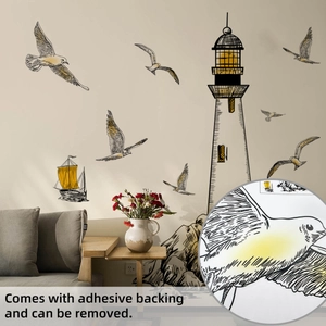 Lighthouse and seagull wall decals set applied above a modern living room sofa