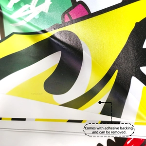 Close-up of yellow cartoon dinosaur skateboard wall sticker showing adhesive backing