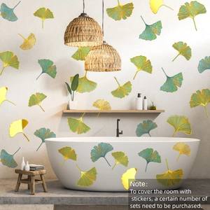 Detailed view of metallic gold and cyan ginkgo leaf wall decals on a modern bathroom wall