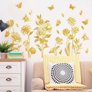 Detail of golden floral and butterfly wall stickers with reflective mirror finish on wall