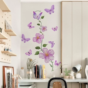 Purple floral vine and butterfly wall stickers applied above a modern white desk setup