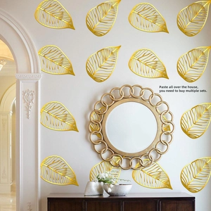 Detail of gold hollowed-out leaf wall stickers with glossy finish for home decoration