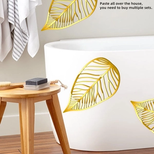 Detail of 3D metallic gold ginkgo leaf wall stickers with cutout veins on a bathtub