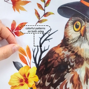 Close-up of double-sided Halloween owl sticker with vivid colorful patterns on both sides