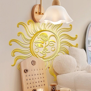Detailed close-up of golden sun face wall sticker with shiny metallic mirror finish
