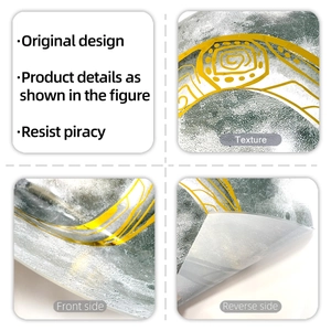 Close-up of textured silver wall sticker with golden artistic lines and flexible backing
