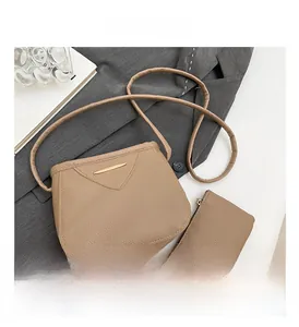 Vue détaillée du lot de deux sacs beige avec texture grainée et finitions métalliques