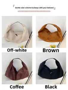 Detail view of four minimalist suede hobo bags in off-white, brown, coffee, and black