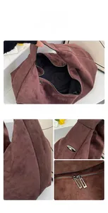 Detail view of large brown suede tote with durable double zippers and internal pocket