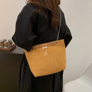 Retro brown suede tote bag with golden chain strap and deer pendant on model