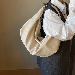 Chic beige ruched shoulder bag with large capacity, shown on model for daily commute style