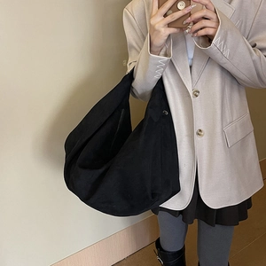 Minimalist black hobo tote bag in soft suede finish shown as a side-view shoulder bag