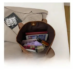 Macro view of spacious interior of dark brown suede tote bag with magnetic clasp and lining