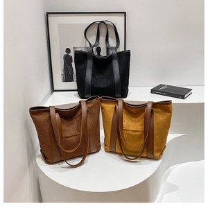 Detailed view of large tote bags in black, coffee, and mustard yellow suede materials