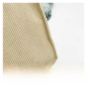 Close-up of premium beige corduroy fabric texture with detailed vertical stripe patterns