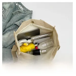 Top view of spacious beige corduroy tote bag showing interior storage for laptop and daily items