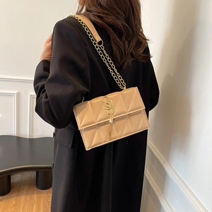 Chic quilted beige crossbody bag with gold chain strap and stylish tassel detail