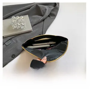 Top view of evening clutch bag interior showing space for phone and cards