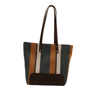 Retro striped canvas tote bag with green, yellow and beige patterns and leather straps