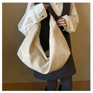 Detail view of large cream hobo tote bag with black zipper and soft matte texture