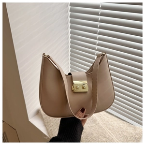 Detail of beige crescent underarm bag with smooth leather finish and golden metal buckle