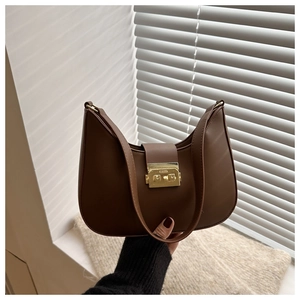 Detail of vintage dark brown hobo bag featuring a retro gold rectangular metal clasp