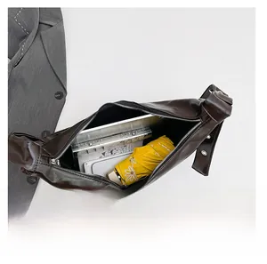 Interior view showing large capacity of the brown crescent bag for tablets and umbrellas