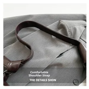 Close-up of a dark brown cloud bag featuring a knotted strap detail and smooth leather texture