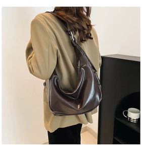 Side view of dark brown hobo shoulder bag with glossy leather and silver zipper detail