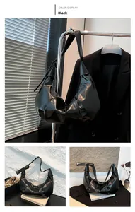 Glossy black pleated shoulder bag detail showing premium texture and slouchy cloud design