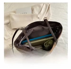 Interior view showing the large capacity for a tablet, notebook, and folding umbrella