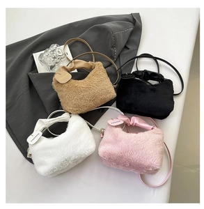 Flat lay of four plush faux fur handbags in khaki, black, white, and pink color variants