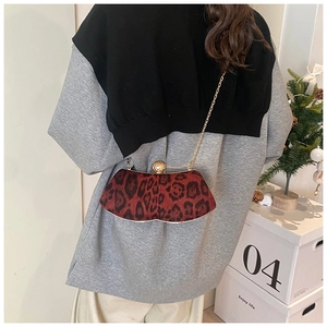 Détail du sac léopard avec bandoulière en chaîne dorée et fermoir élégant en boucle perle