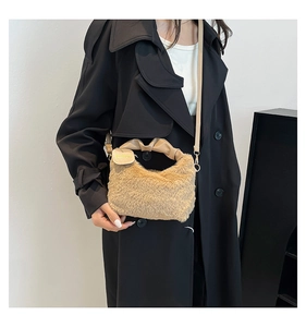 Model wearing a plush faux fur handbag with ruched PU leather handles in light khaki