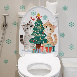 Close-up of cute cartoon cats with Christmas tree wall stickers on a bathroom wall