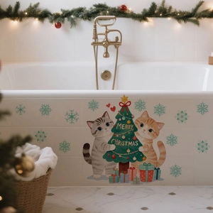 Detail of Christmas cat and tree wall stickers applied to a white bathtub surface