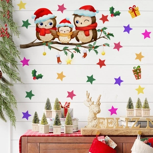 Detail of Christmas wall stickers featuring owls with hats and gift boxes on a white wall