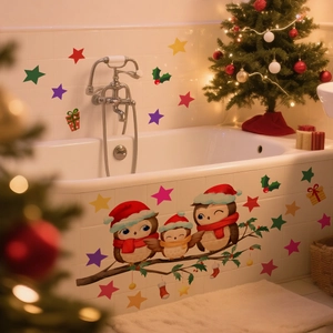Christmas wall stickers with cartoon owls and stars applied on a smooth bathroom wall