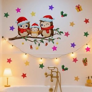 Detail of owl family wall stickers with Christmas stars and gifts on white tile background