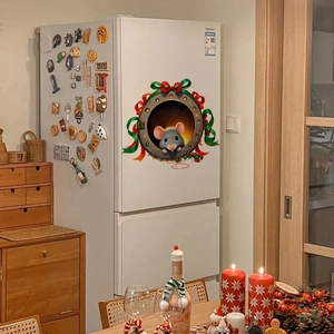 Detail of 3D Christmas squirrel wall sticker with red ribbon on a white refrigerator surface