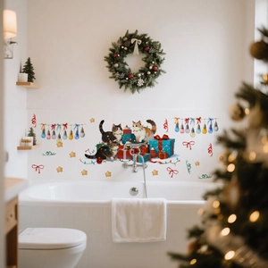Detail of Christmas cat wall stickers with gift boxes and stars on white bathroom tiles