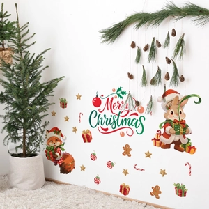 Detail view of festive squirrel and bunny Christmas wall decals on a white living room wall