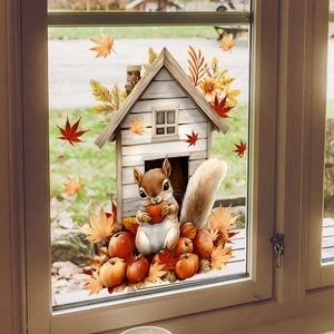 Detail of autumn window decals showing a cozy cabin and squirrel on glass