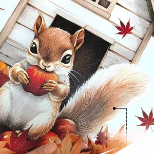 Close-up of squirrel and maple leaf window sticker showing double-sided color patterns