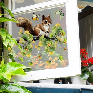 Detail of squirrel and butterfly window stickers on glass with ginkgo leaf patterns