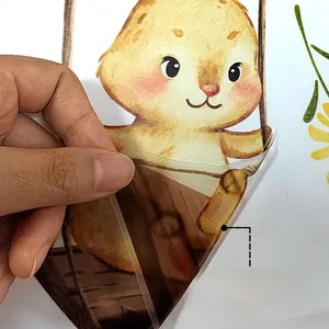 Detail of self-adhesive bear wall sticker showing easy removal from white surface