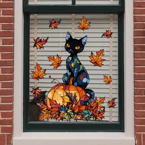 Close-up of autumn window cling featuring a black cat on a pumpkin with maple leaves